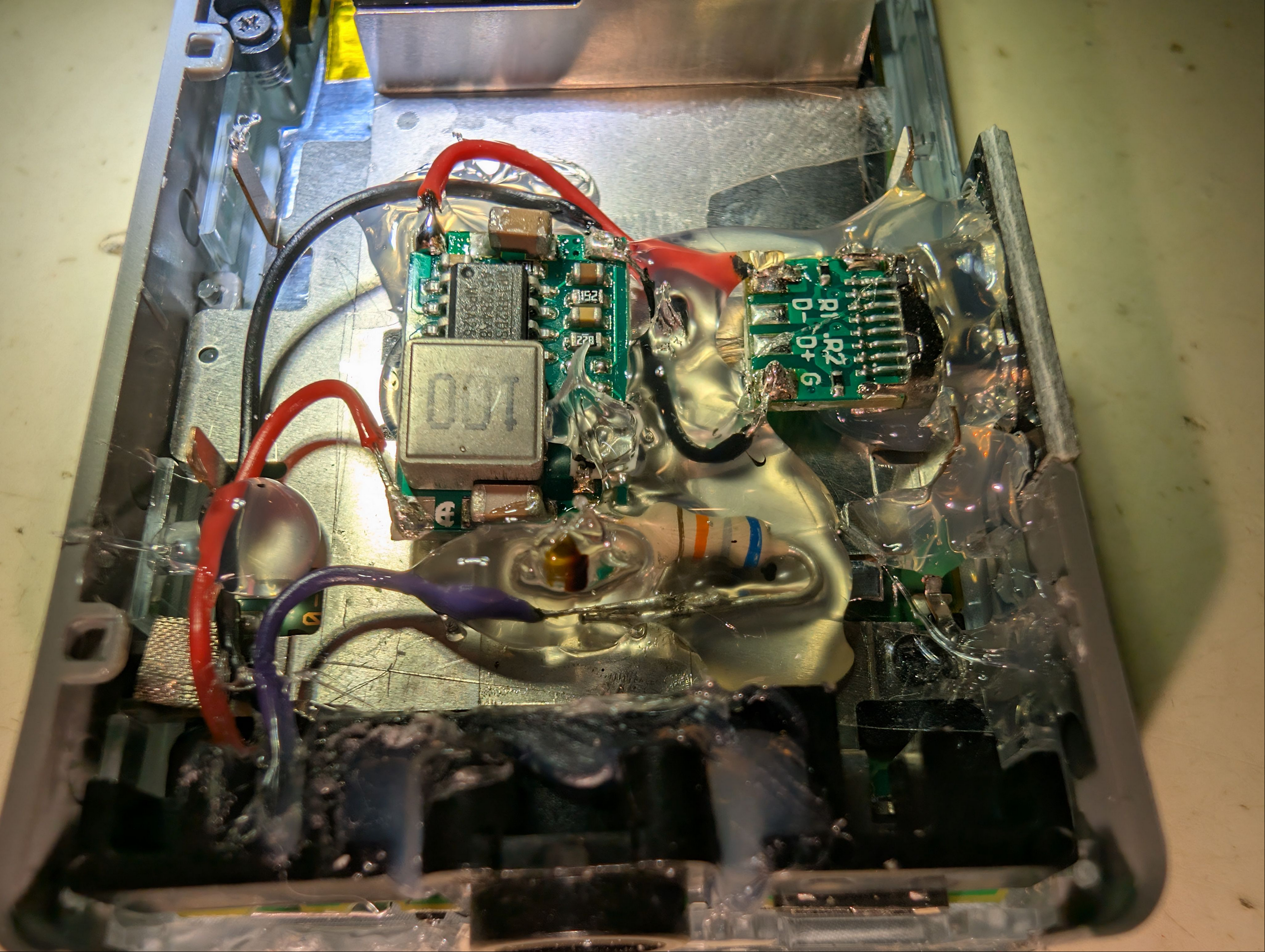 Here should be an image of the 'Hotglued mess inside the battery cavity'